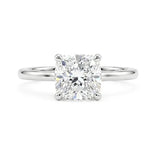 Cushion cut diamond solitaire ring with a four-prong setting on a slim polished white gold band.