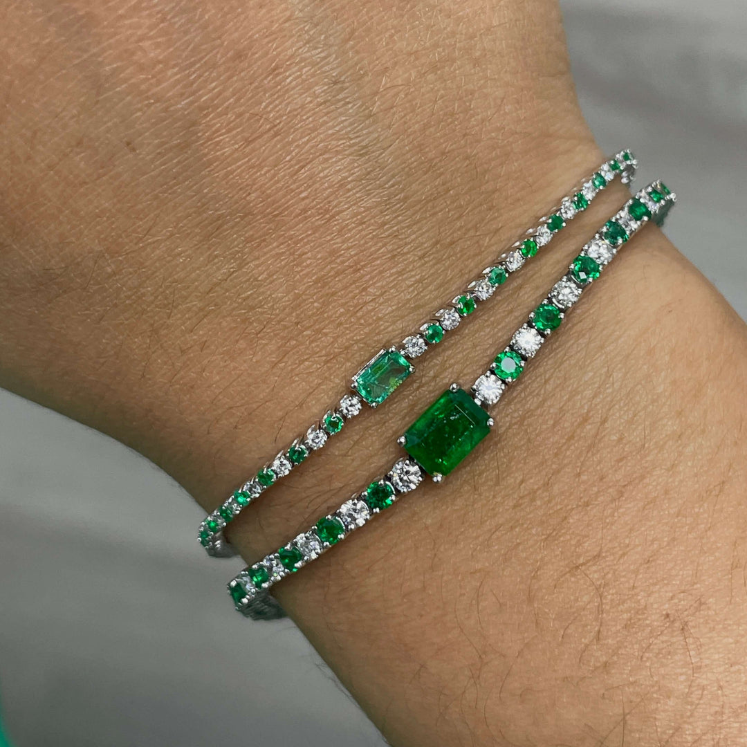 emerald center stone bracelet with alternating round diamonds and emeralds in 14k white gold