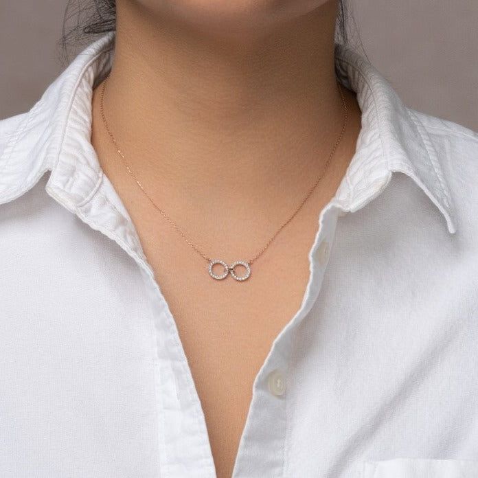 unique jewelry, unique necklace, fashion jewelry, fashion necklace, diamond necklace in rose gold, two circle shaped diamond motifs hanging horizontally connected in the middle by gold bar. Perfect for layering necklace.