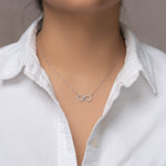 Load image into Gallery viewer, unique jewelry, unique necklace, fashion jewelry, fashion necklace, diamond necklace in white gold, two circle shaped diamond motifs hanging horizontally connected in the middle by gold bar. Perfect for layering necklace. Necklace is being worn by model.
