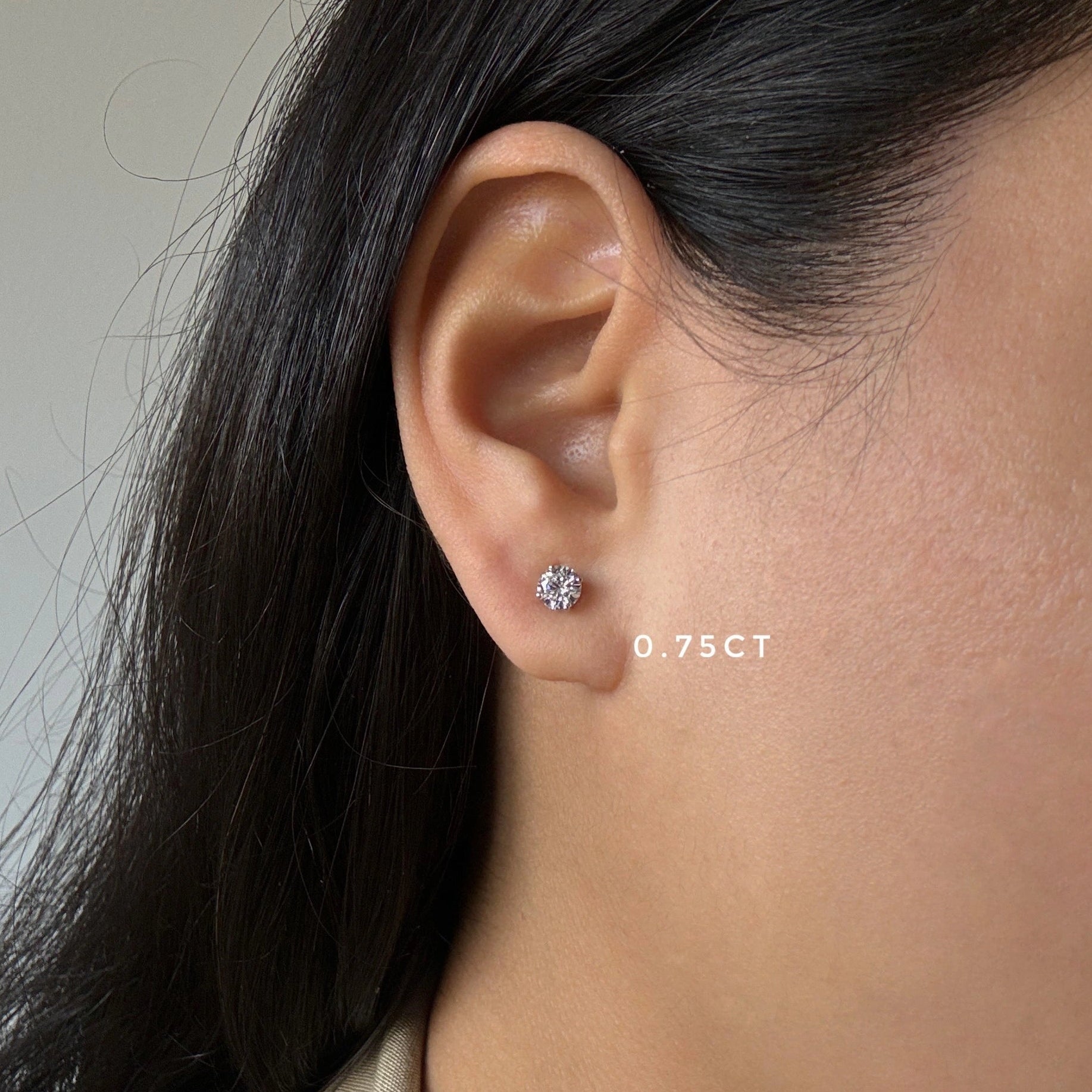 3/4ct diamond stud earrings in white gold on ear