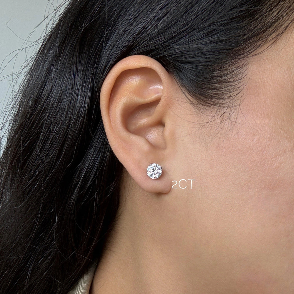 2ct diamond stud earrings in white gold on ear