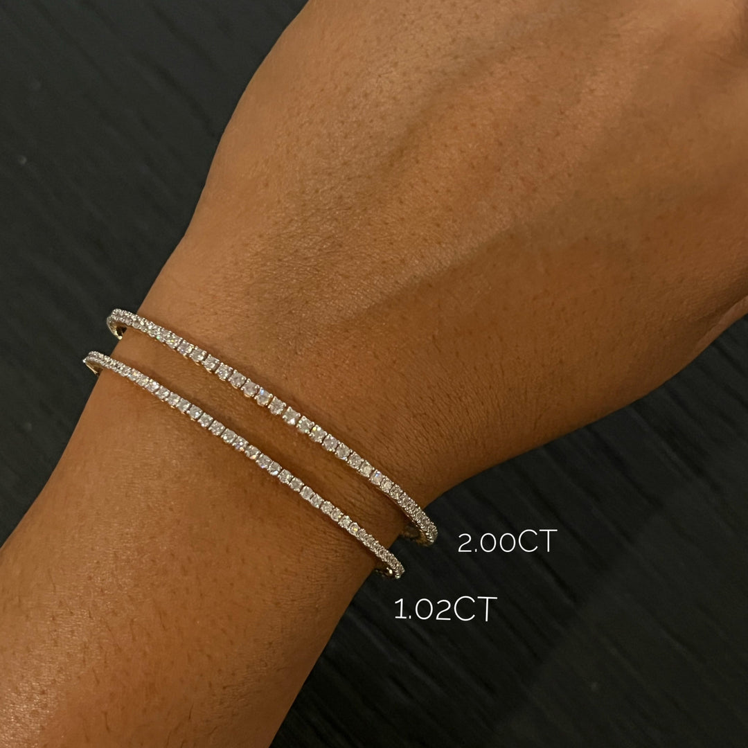 stackable diamond bracelets on model in 14k yellow gold