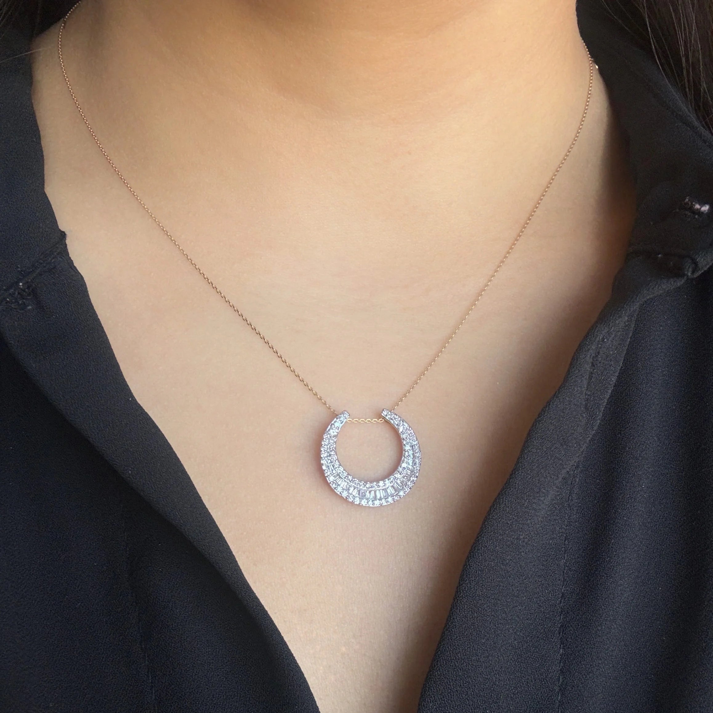 diamond moon shaped necklace in yellow gold with round and baguette diamonds
