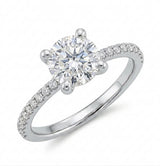 Round diamond engagement ring with a four-prong setting and a pavé diamond band in white gold