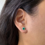 emerald studs with diamond halo in gold