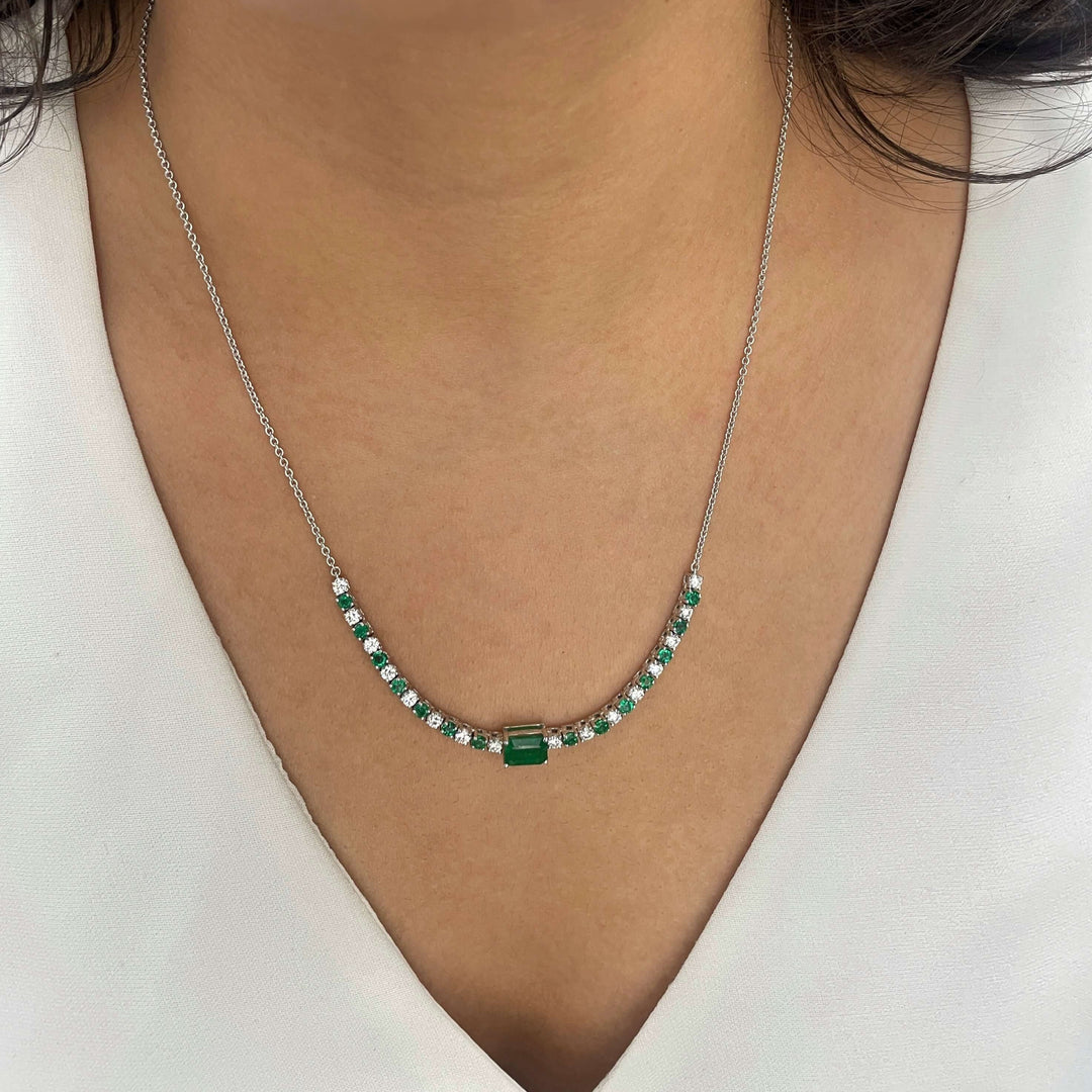 emerald center stone necklace with alternating round diamonds and emeralds in 14k white gold