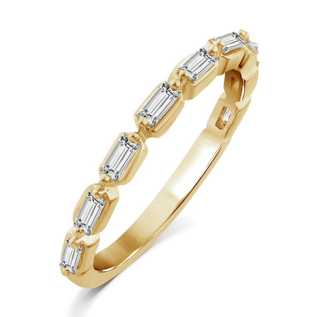 yellow gold diamond band ring with sideways baguette diamonds set between two prongs going half way eternity