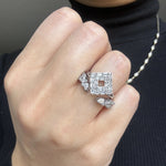 round diamond and marquise diamond wedding band ring with gap in the middle stacked with diamond engagement ring