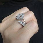 round diamond and marquise diamond wedding band ring with gap in the middle stacked with diamond engagement ring