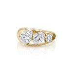 yellow gold three stone ring featuring a pear cut diamond, an oval cut diamond, and an Asscher cut diamond descending in size.