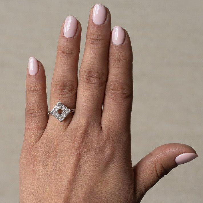 Origins diamond ring worn on a hand