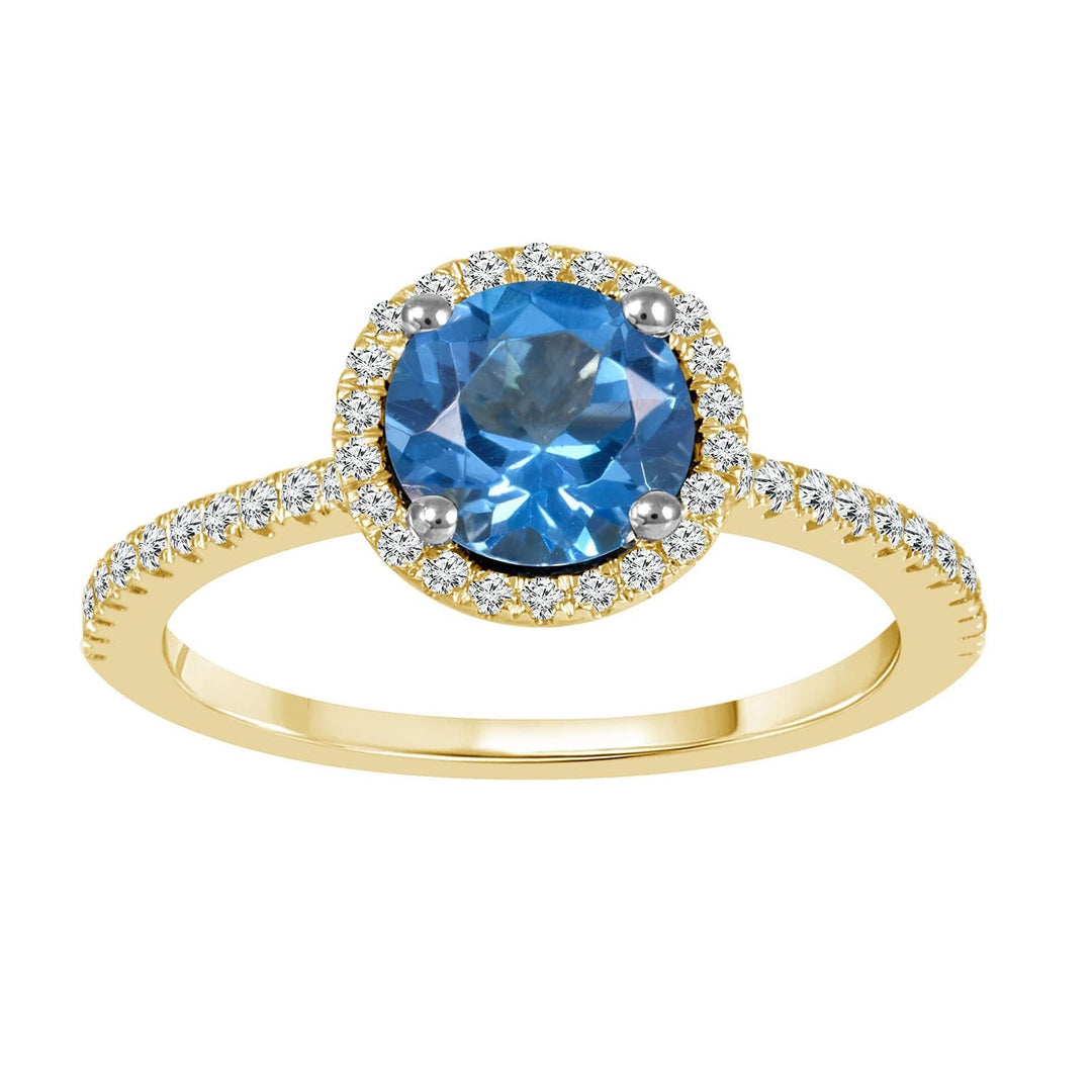 Blue Topaz and diamond ring in 14k yellow gold. Round blue topaz with diamond halo and diamonds on shank