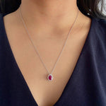oval shaped ruby pendant with diamond halo in 14k white gold 