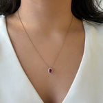 Load image into Gallery viewer, oval shaped ruby pendant with diamond halo in 14k yellow gold 
