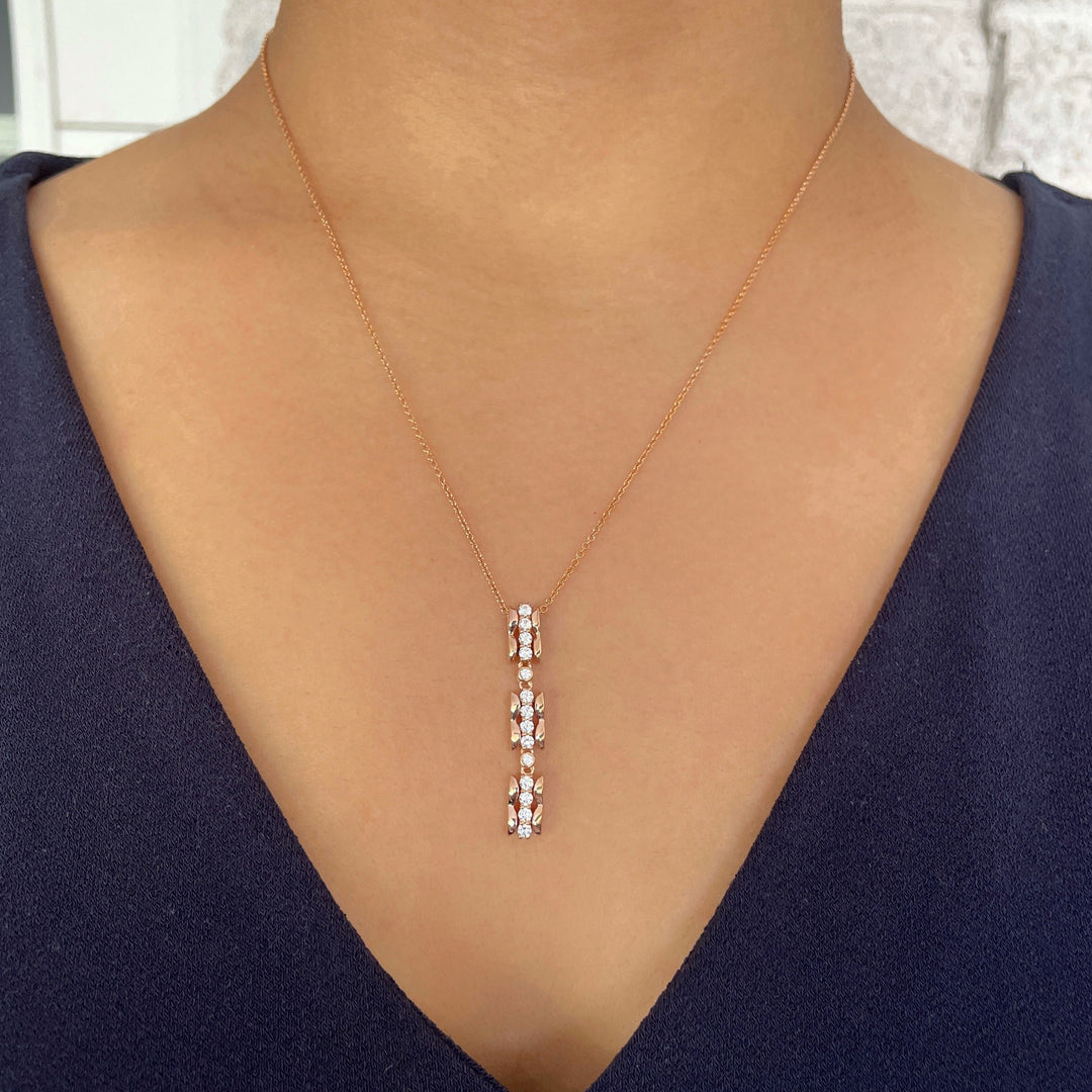 scalloped texture long vertical pendant with diamonds in 14k rose gold