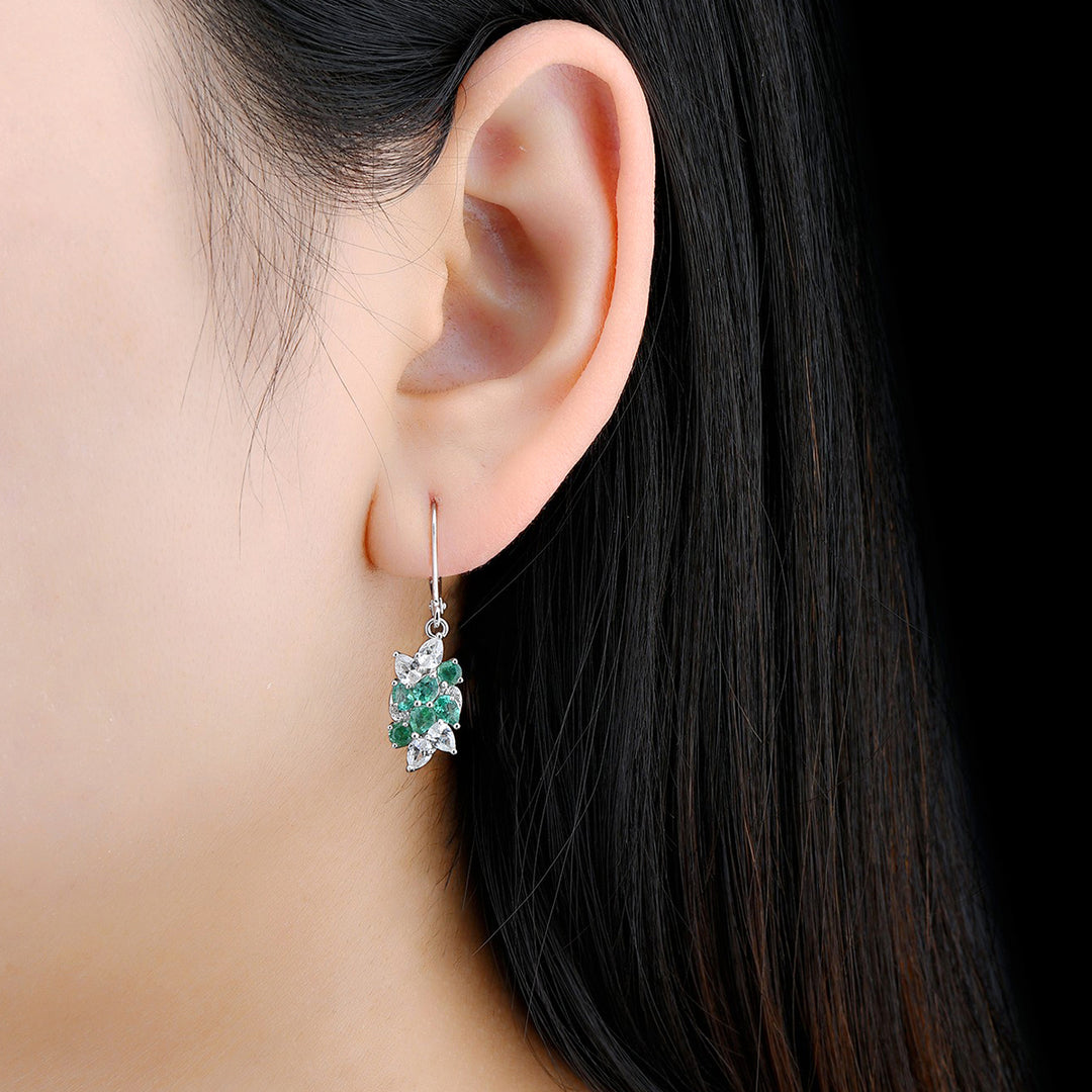 Pear Shape Emerald and White Zircon Dangle Earrings in Sterling Silver on model