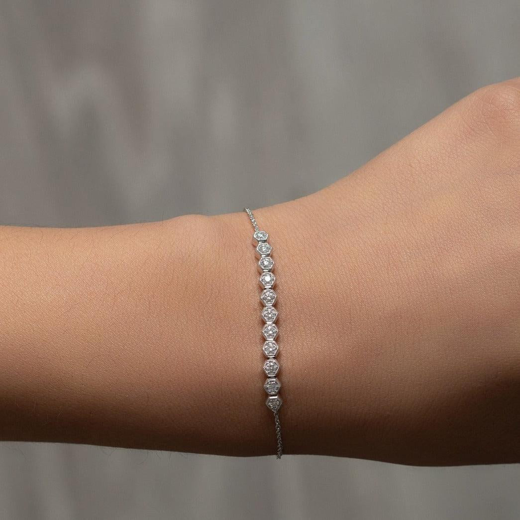 White Gold chain bracelet with a bar of diamonds in a hexagonal setting worn on a wrist