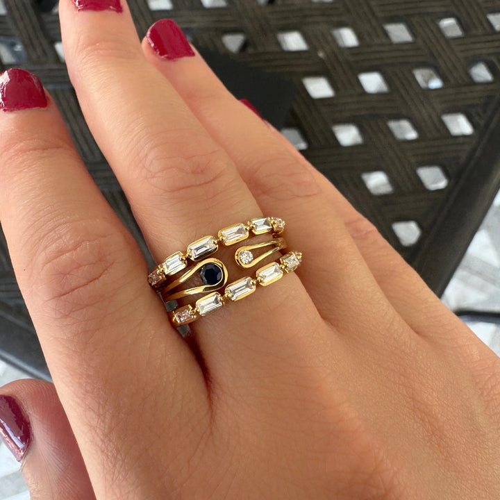 yellow gold sapphire and diamond band ring stacked between yellow gold diamond baguette wedding band rings