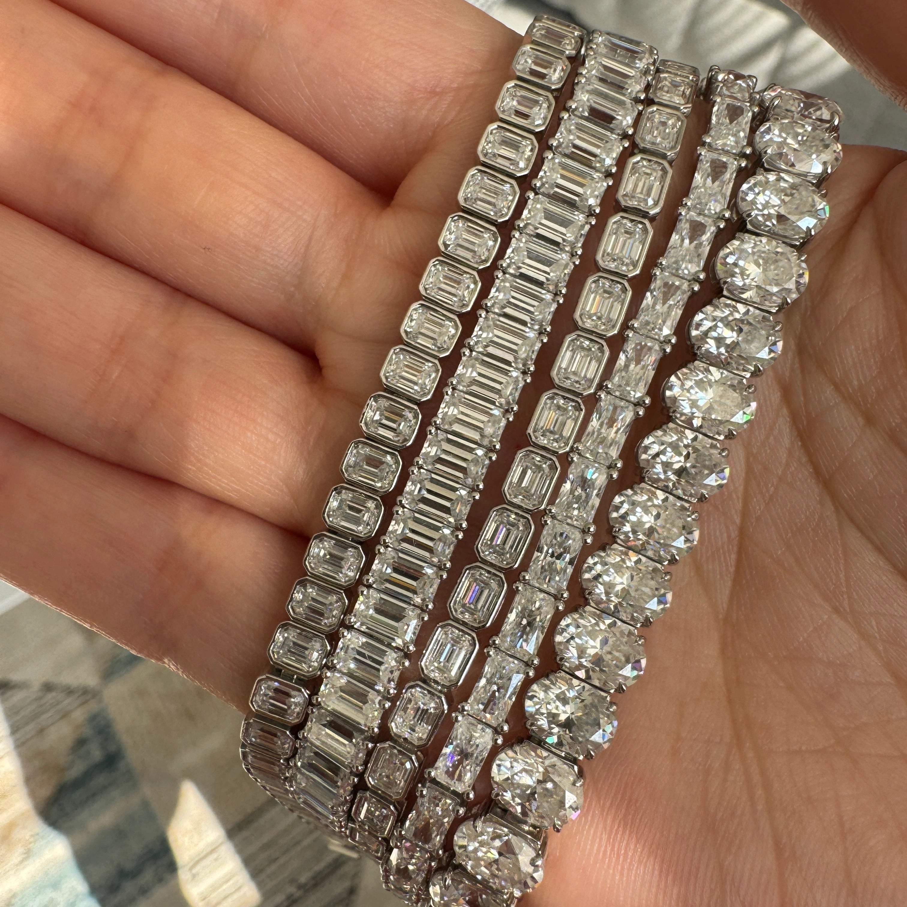 lab grown diamond tennis bracelets stacked displayed on a hand