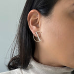Load image into Gallery viewer, half circle motif earrings with a bar going through the circle. Bar has 5 diamonds.
