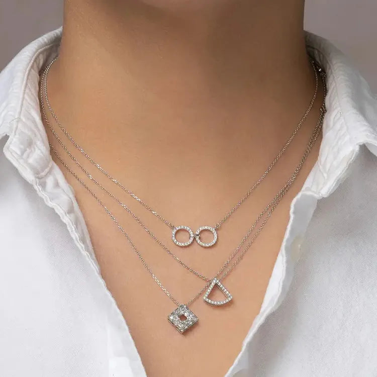 Model is wearing layering necklaces. All are diamond necklaces. All are diamond fashion necklaces and all are geoart jewelry.