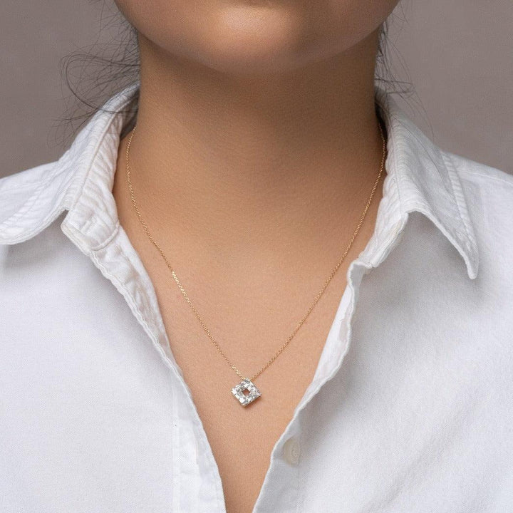 Yellow Gold Origins Baguette Diamond Pendant worn on a woman