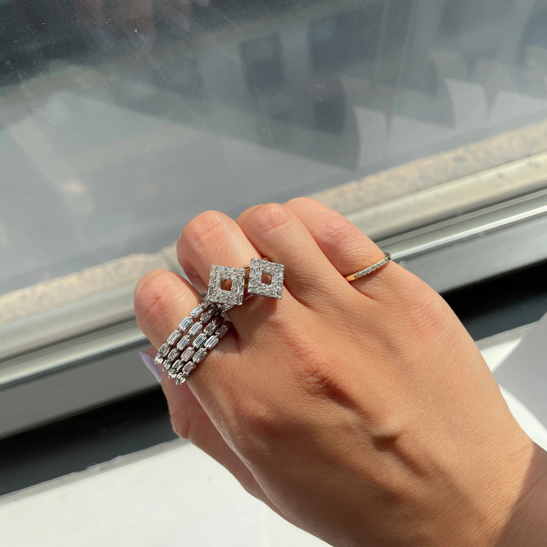 stacked white gold baguette diamond band rings worn with baguette diamond rings in a diamond shape and pinky ring