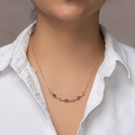 Load image into Gallery viewer, gemstone necklace with pastel pink tourmaline and pastel blue swiss blue topaz and white sapphires in different shapes. Pink tourmaline in oval shape blue topaz and white sapphire in round shape. Metal is 18k gold over silver vermeil. Chain is adjustable so can layer necklace. Necklace on model.