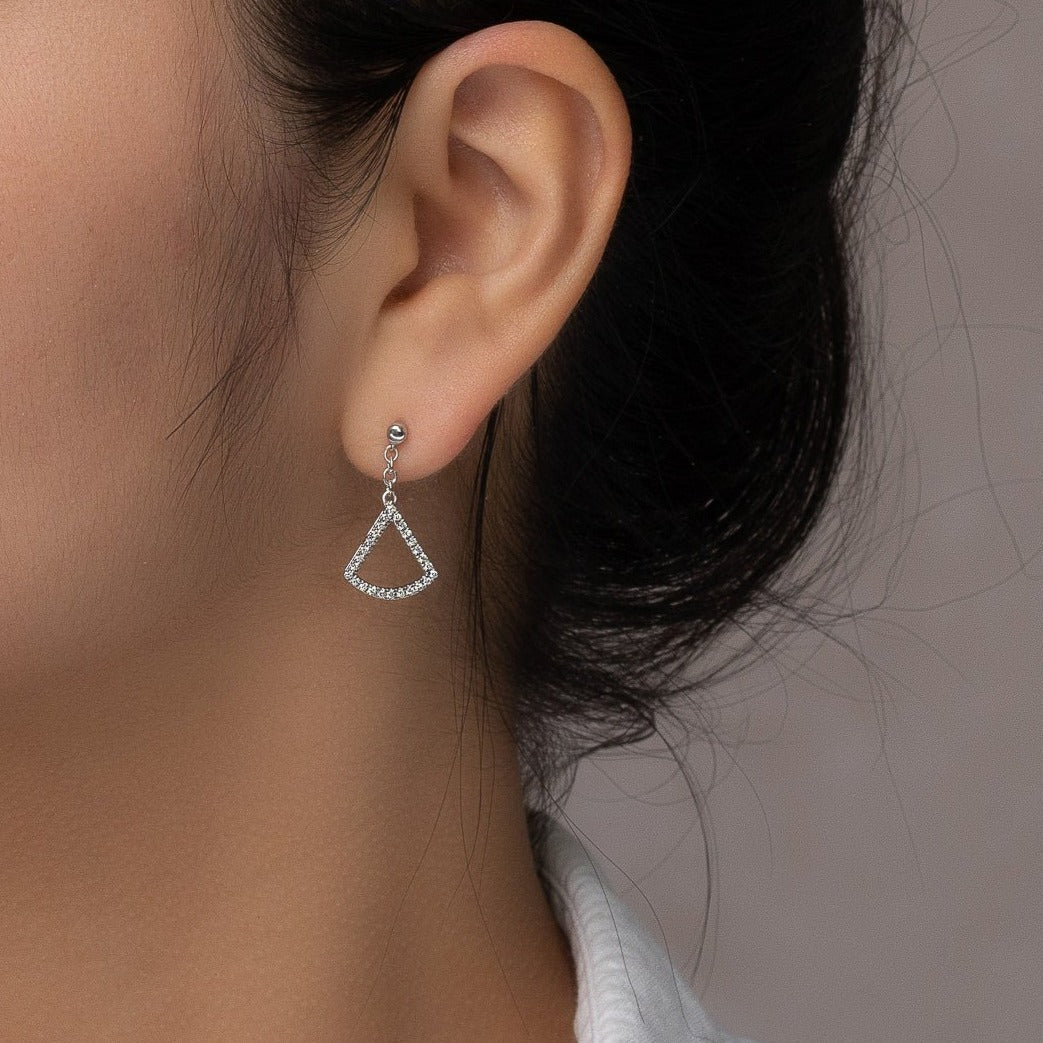 unique jewelry, unique earrings, fashion jewelry, fashion earrings, diamond earrings in white gold, dangling earrings, dangling diamond earrings, drop earrings, diamond drop earrings, fan shaped motif connected to cable chain that creates the dangle. Earrings on model.