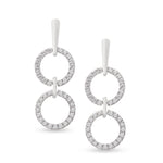 white gold dangling diamond earrings with two open circles connected by a metal bar on model. Unique jewelry, unique earrings. gladiator style earrings.