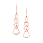 unique jewelry, unique earrings, fashion jewelry, fashion earrings, drop earrings in rose gold, dangling earrings, dangling drop earrings with a design of geometric shapes intertwined with each other. Earrings have a fishhook back. Earrings on model.