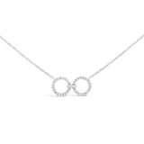 unique jewelry, unique necklace, fashion jewelry, fashion necklace, diamond necklace in white gold, two circle shaped diamond motifs hanging horizontally connected in the middle by gold bar. Perfect for layering necklace. Necklace is being worn by model.