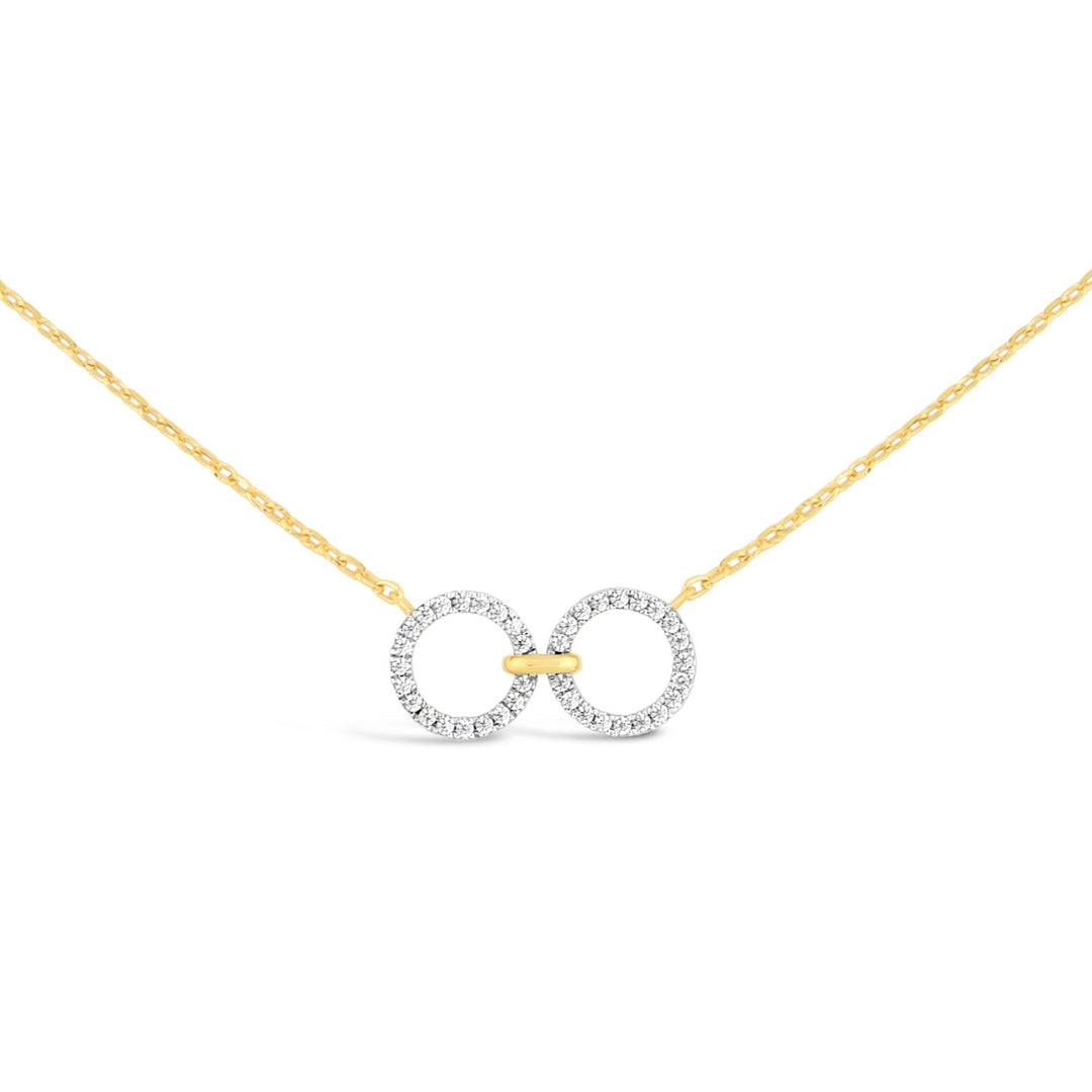 unique jewelry, unique necklace, fashion jewelry, fashion necklace, diamond necklace in yellow gold, two circle shaped diamond motifs hanging horizontally connected in the middle by gold bar. Perfect for layering necklace. Necklace is being worn by model.