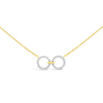 unique jewelry, unique necklace, fashion jewelry, fashion necklace, diamond necklace in yellow gold, two circle shaped diamond motifs hanging horizontally connected in the middle by gold bar. Perfect for layering necklace. Necklace is being worn by model.