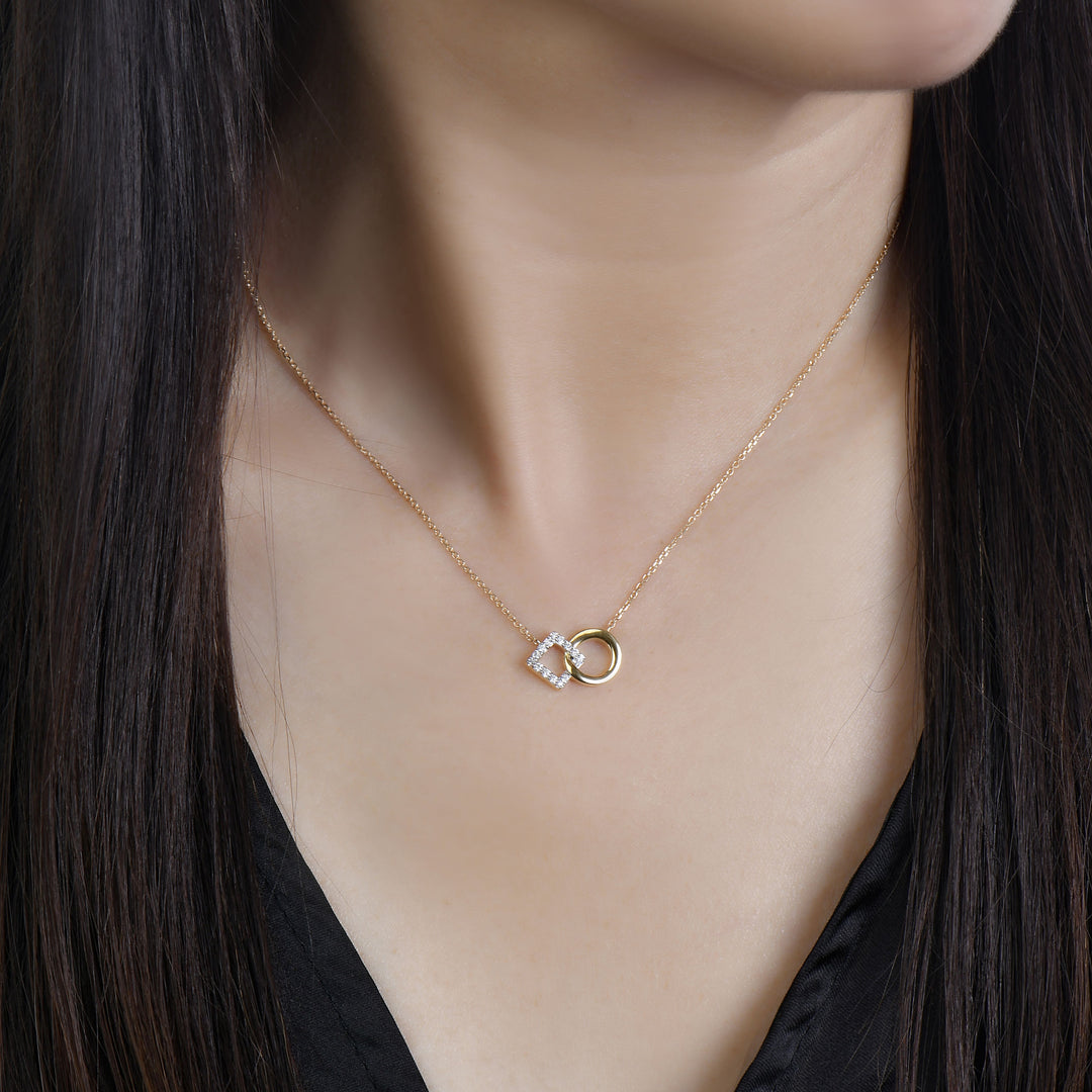 14k yellow gold necklace with diamonds in a connected diamond motif and cirlce motif on model