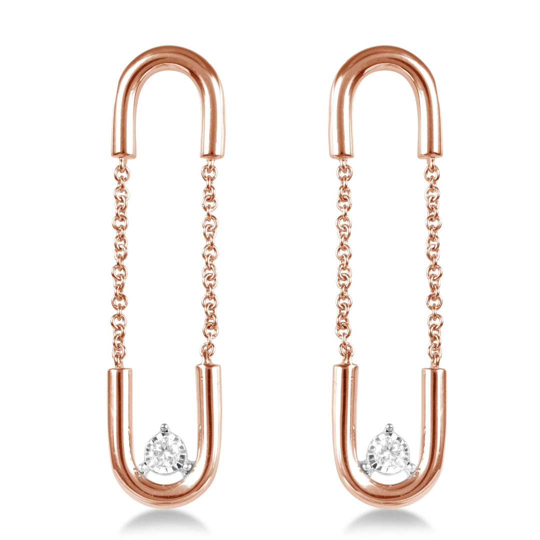 unique jewelry, unique earrings, hanging earrings, dangling earrings, single diamond in the middle of each earring, rose gold dangling diamond earrings, hanging earrings with chain links, paperclip earrings, safety pin earrings. Earrings on model.