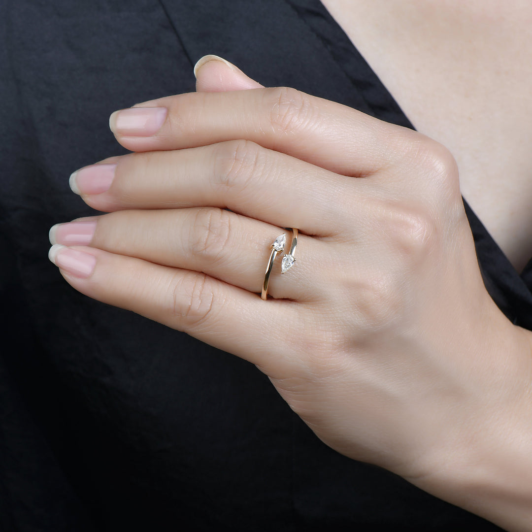 model wearing a toi et moi diamond ring with two pear diamonds in 14k gold